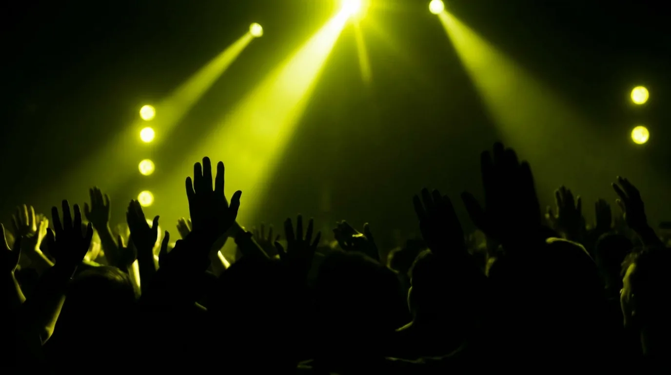 Pubblico dell'AI Music Fest di Future Frequencies HUB sotto luci gialle neon